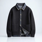 Black ribbed knit cardigan with denim collar and pocket trim on a white background