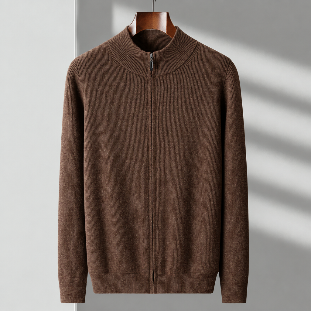 A brown ribbed knit zip-up sweater with a mock neck collar, hanging on a wooden hanger against a light gray wall with soft diagonal shadows.