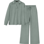 A two-piece lounge set in sage green, featuring a long-sleeve collared top with a textured geometric pattern and matching wide-leg pants with an elastic drawstring waist.