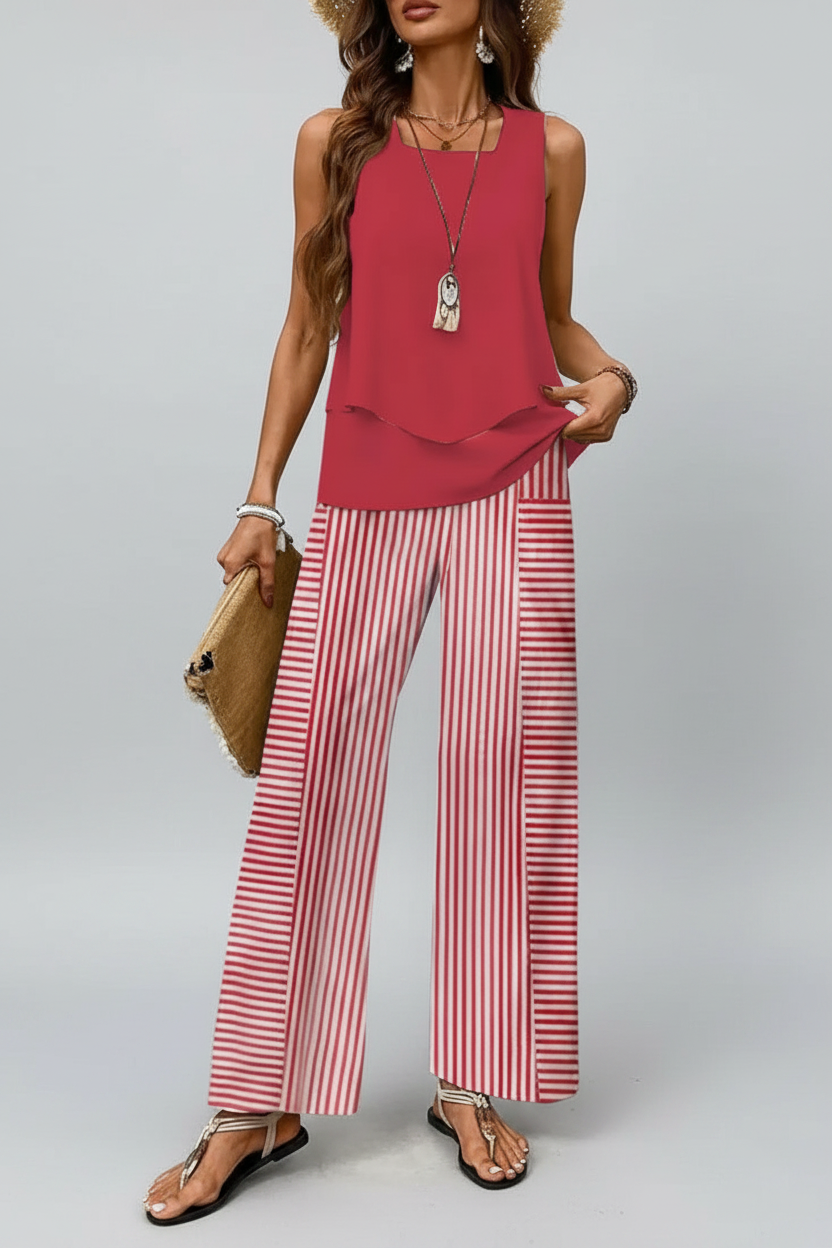 Woman wearing a red top and red and white striped pants against a neutral background