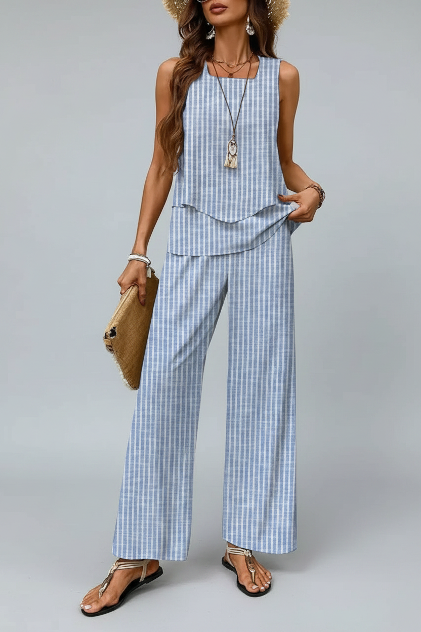 Woman wearing a blue and white striped outfit against a neutral background