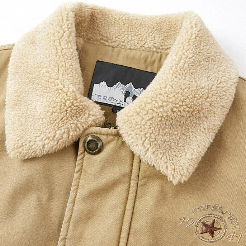 Close-up of a beige jacket with a fluffy collar and a brand label on a white background.