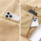 Phone in a pocket of beige fleece and pants