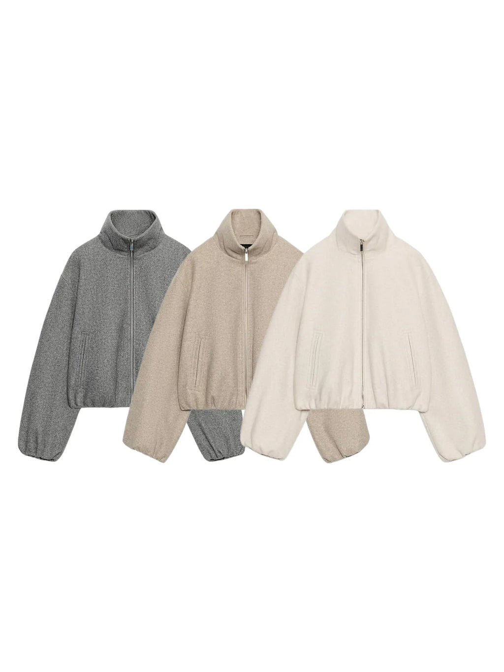 Three cropped quarter-zip jackets in heather gray, beige, and cream, arranged side-by-side on a plain white background.