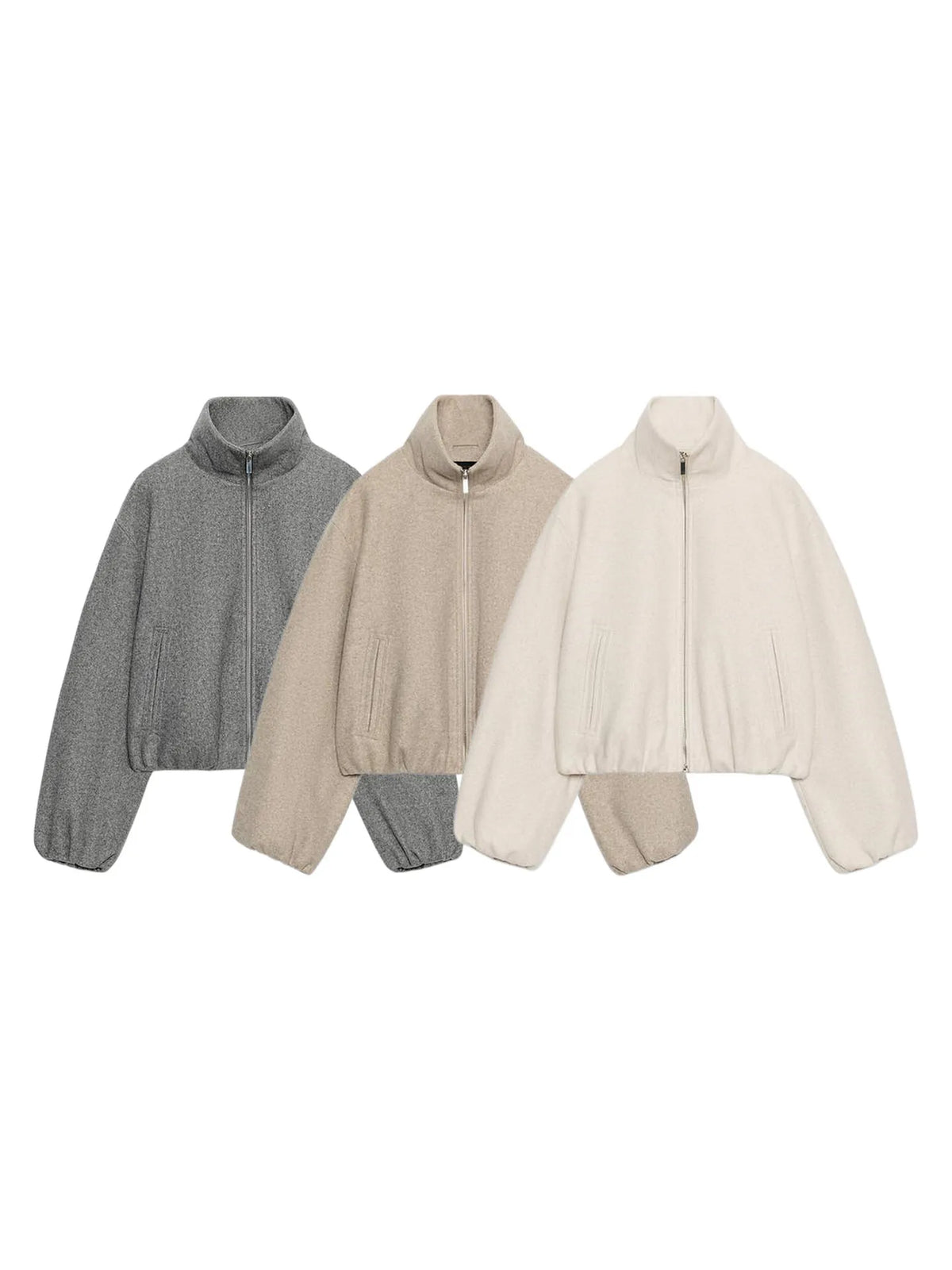Three cropped quarter-zip jackets in heather gray, beige, and cream, arranged side-by-side on a plain white background.
