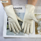 Beige leather gloves on a magazine with 'AGAZEE' branding.