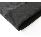 Close-up of a dark gray ribbed knit cuff with a soft, plush fleece lining visible along the edge, set against a plain white background.