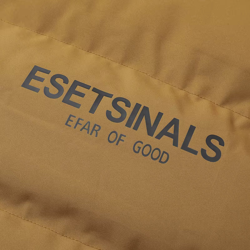 Close-up of a tan or camel-colored fabric surface with dark gray printed text reading 'ESETSINALS' and smaller text 'EFAR OF GOOD'.