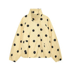 A cream-colored lightweight jacket with a black polka dot pattern, featuring a stand-up collar and front zipper closure, shown against a plain white background.
