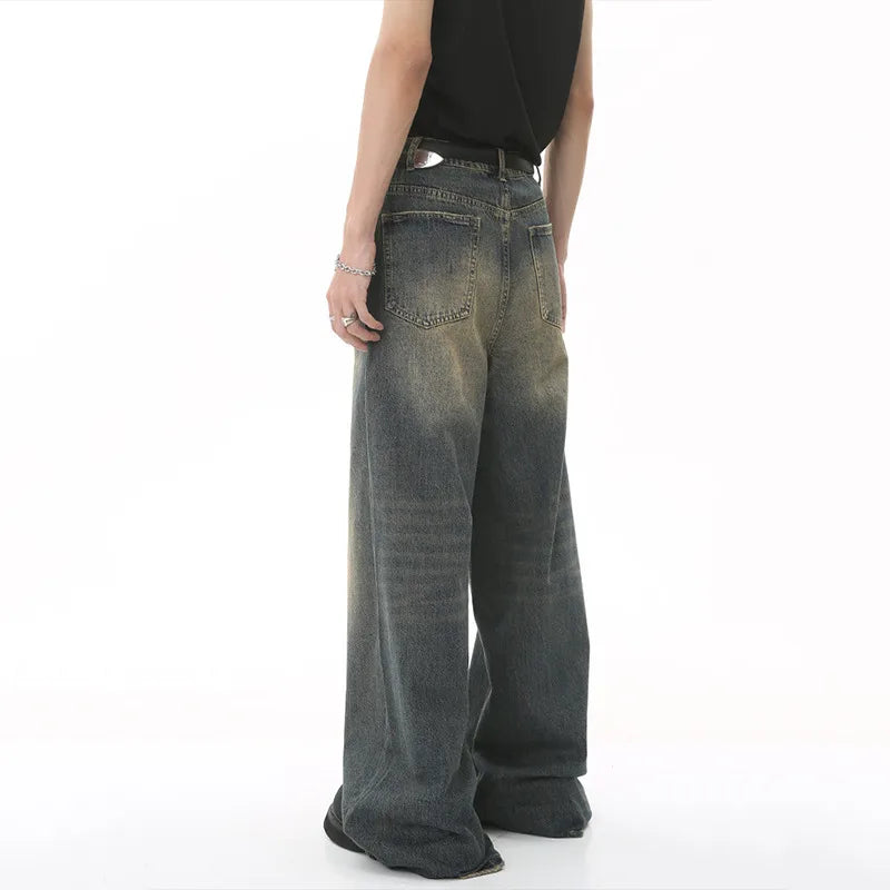 Person wearing a pair of wide-leg jeans on a white background