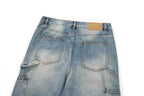 Back view of light blue denim jeans showing the waistband, belt loops, back pockets, and a small tan leather patch on a white background.