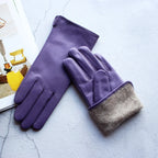 Purple gloves with a gray cuff on a light blue surface