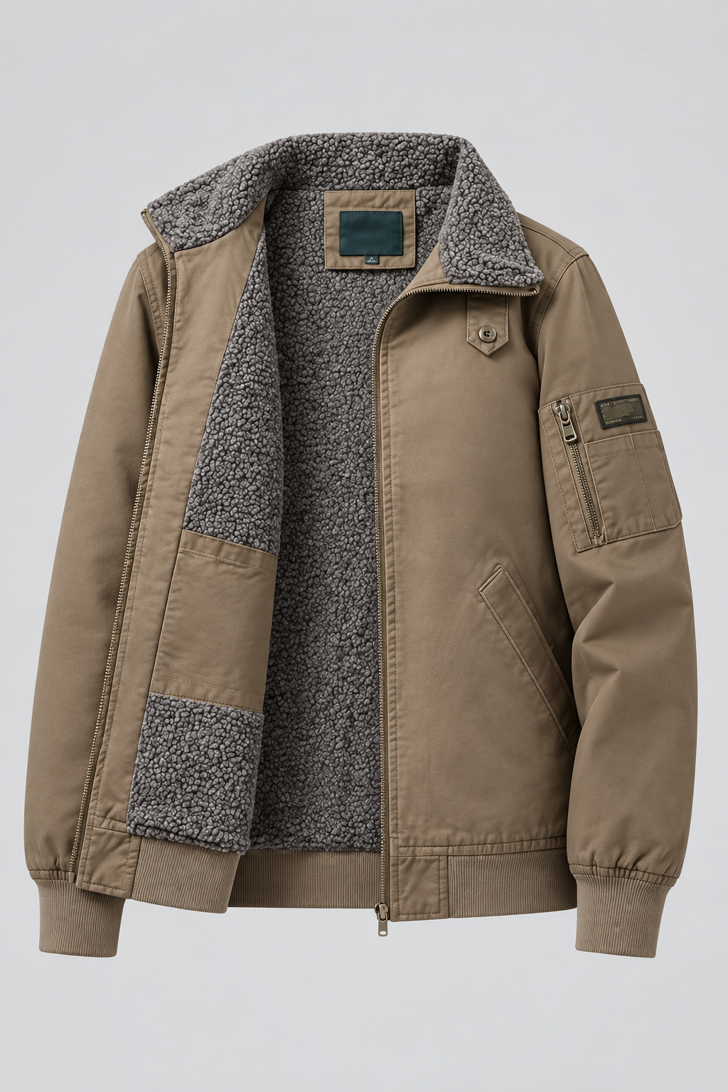 A tan utility-style jacket with a gray speckled sherpa lining, shown on a light gray background. The jacket features a zippered front, a buttoned collar, a chest zip pocket, and a lower zip pocket.