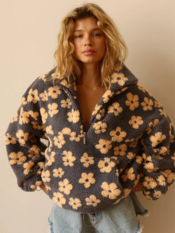 Woman wearing a floral patterned jacket against a beige background
