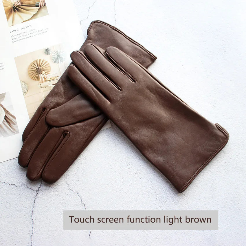 Pair of light brown leather gloves with touch screen function on a white background