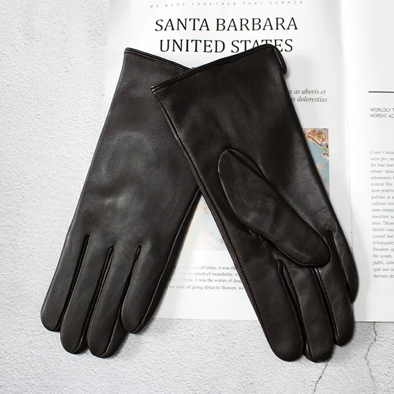 Pair of black leather gloves on a magazine with 'Santa Barbara United States' text.