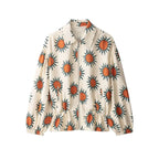 A cream-colored lightweight jacket featuring an all-over sunburst pattern in orange and dark teal, shown against a plain white background.