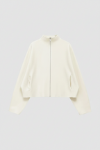 An off-white cropped jacket with a high mock neck, front zipper, and zippered hand pockets, shown against a light gray background.