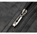 Close-up of a black textured fabric zipper with a metallic silver pull tab.