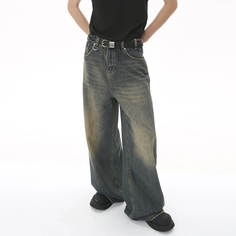 Person wearing wide-leg jeans on a white background