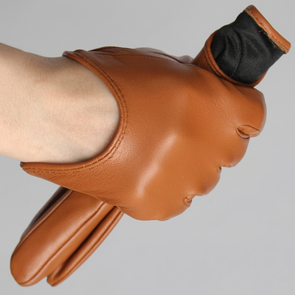 A close-up of a hand wearing a tan leather glove with a black cuff, shown against a plain light gray background.