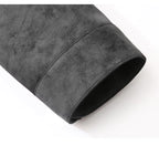A close-up of a dark gray suede or microfiber sleeve, showing the soft texture and rolled cuff detail on a white background.