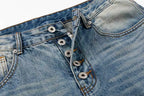 Close-up of a pair of light blue denim jeans showing the button fly, belt loops, and front pocket details.