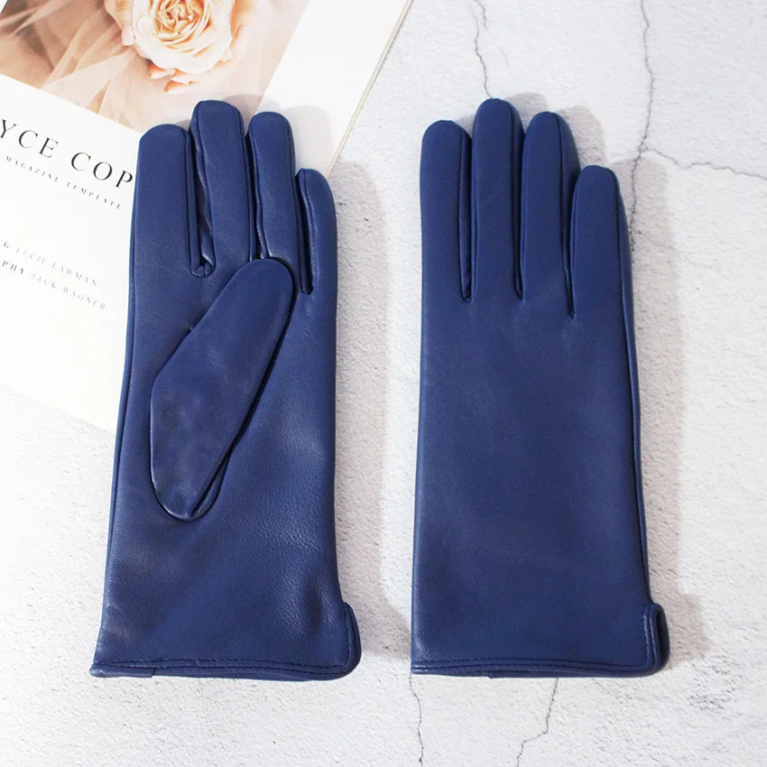 Pair of blue gloves on a textured white surface