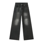 Black distressed jeans on a white background