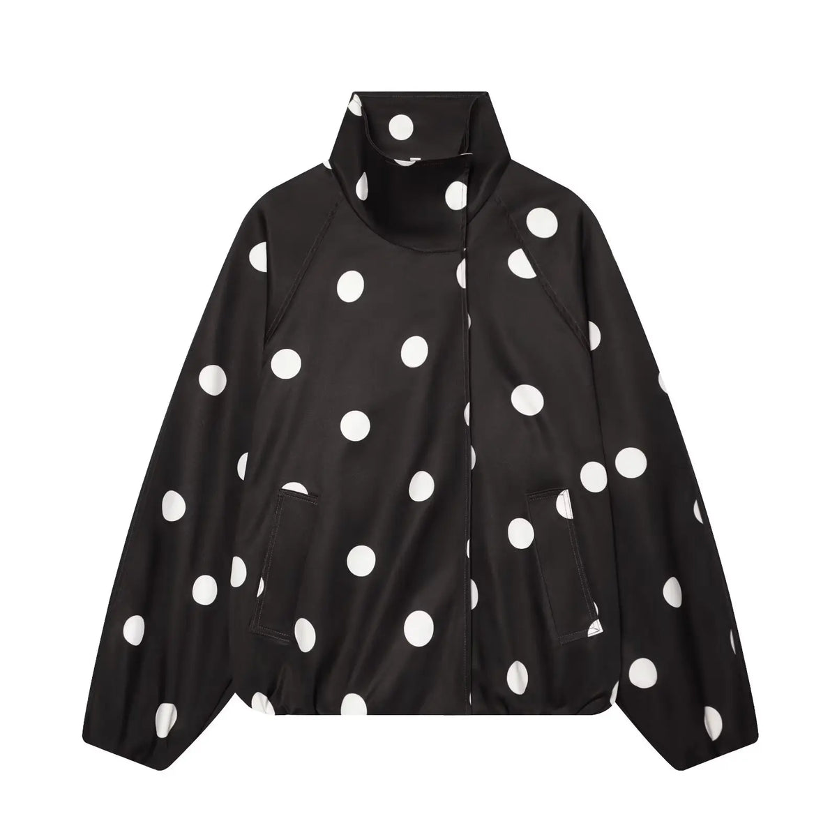 A black zip-up jacket with a high stand-up collar, featuring a bold white polka dot pattern, displayed against a solid white background.