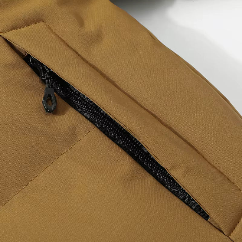 Close-up of a brown jacket with a black zipper on a white background