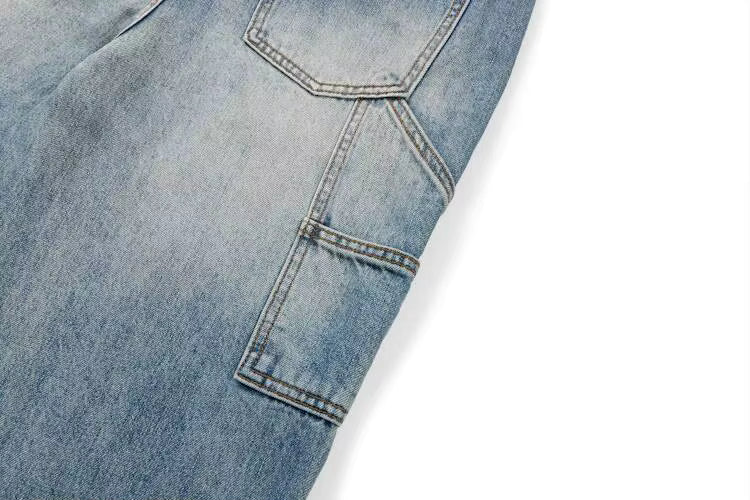 Close-up of light blue denim jeans showing the back pocket and fabric texture on a white background.
