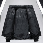Black puffer jacket interior lining shown open against a white background, with elastic cuffs and a small white tag near the lower right side. A small label in the top-left corner reads '変中' in Chinese.