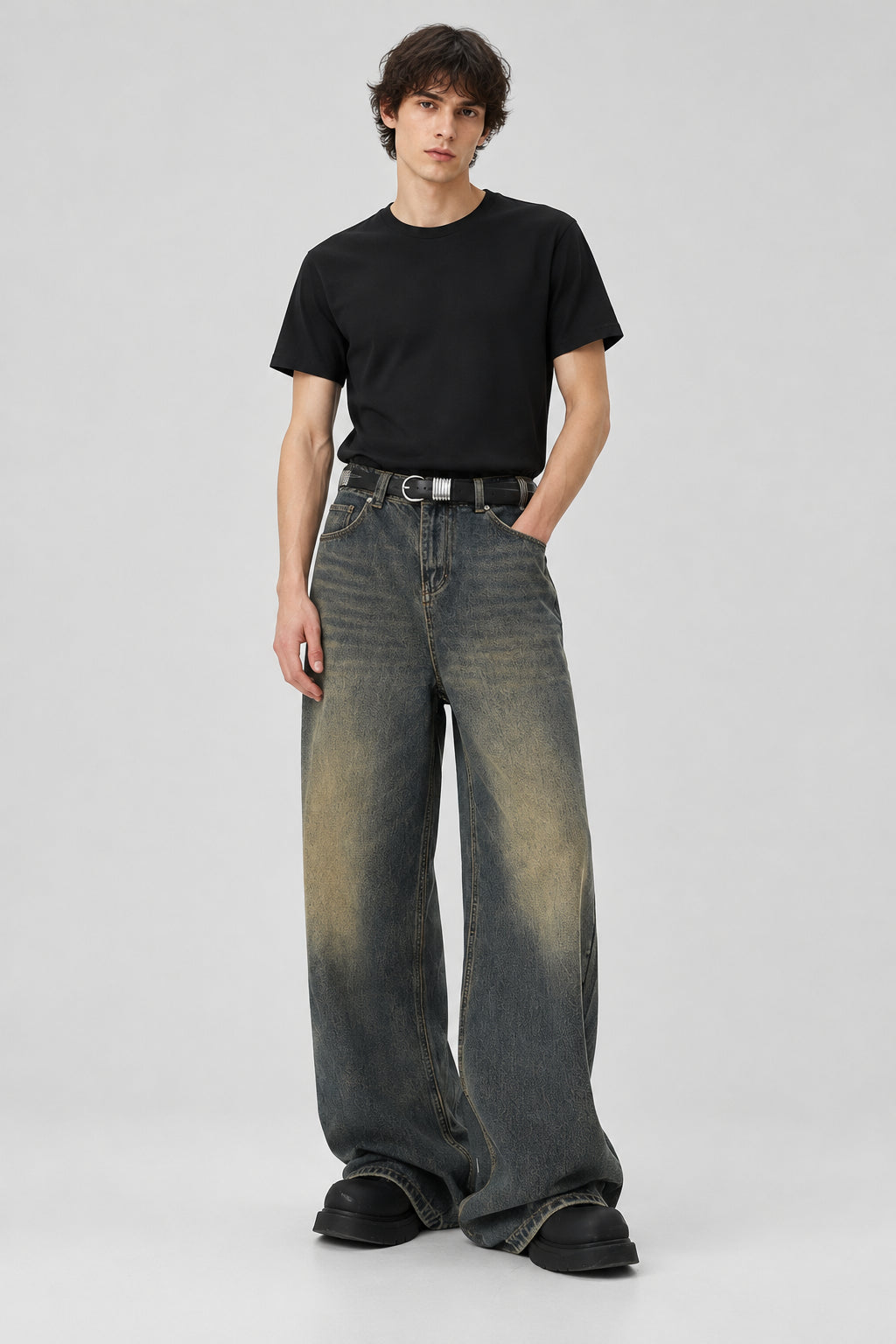 Person wearing a pair of wide-leg jeans on a white background