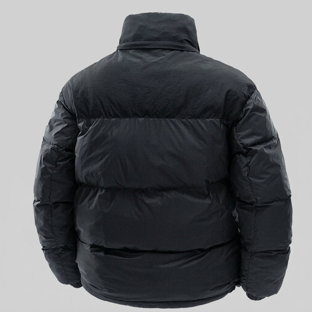 Black puffer jacket shown from the back, featuring horizontal quilting, a high stand-up collar, and a smooth matte finish on a white background.