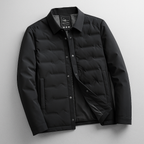 A black men's quilted puffer jacket with a button-up front, collar, and zippered hand pocket, shown against a neutral gray background.