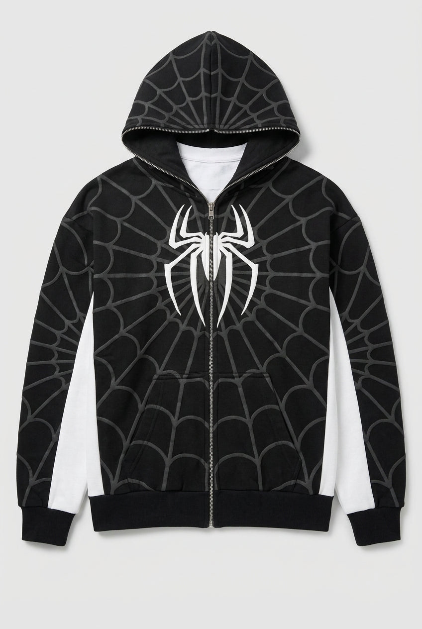 Person wearing a black hoodie with a white spider emblem in an indoor setting