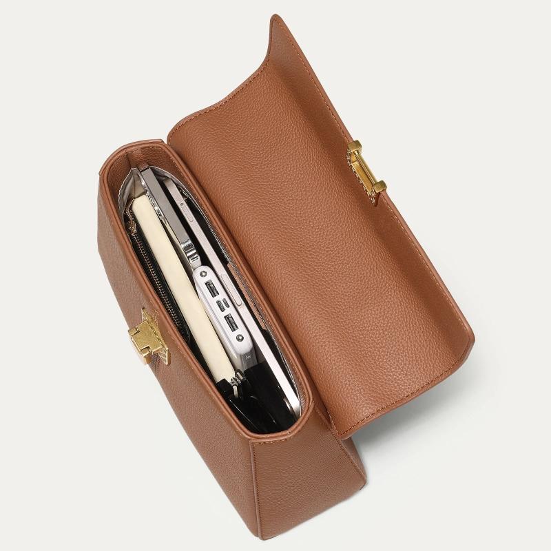 Brown leather clutch with gold clasp on a light gray background