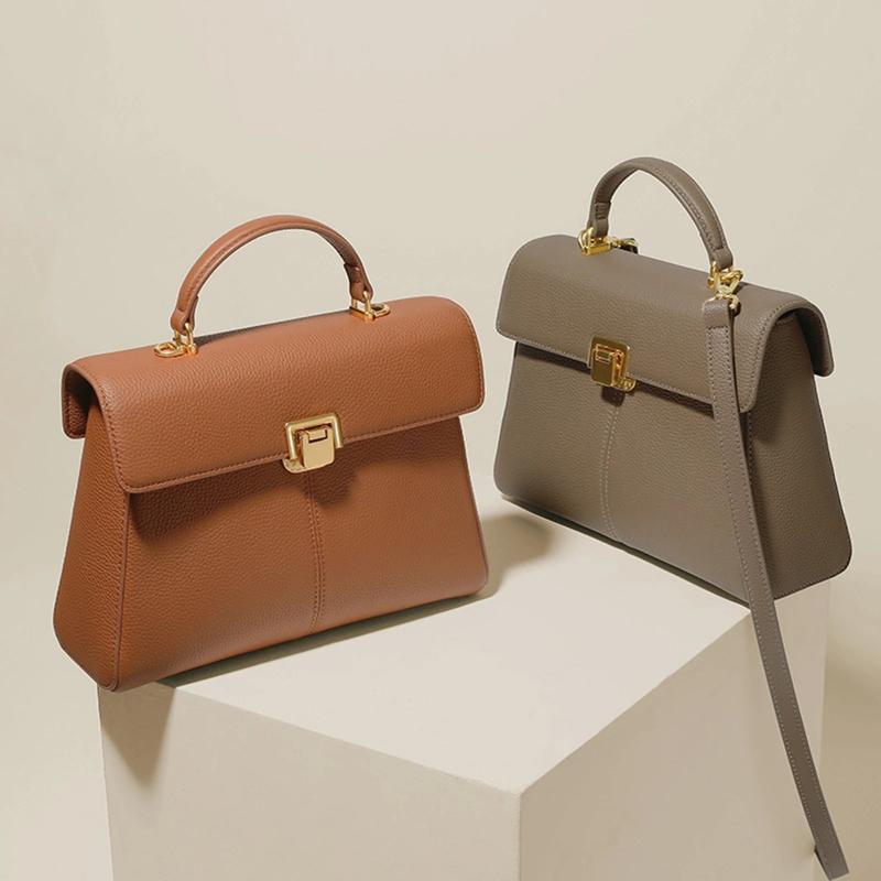 Two handbags, one brown and one gray, on a light beige background.