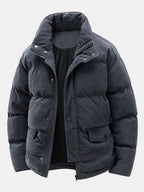 Dark gray puffer jacket on a light gray background
