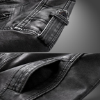 Close-up of a black leather jacket with stitching details on a gray background
