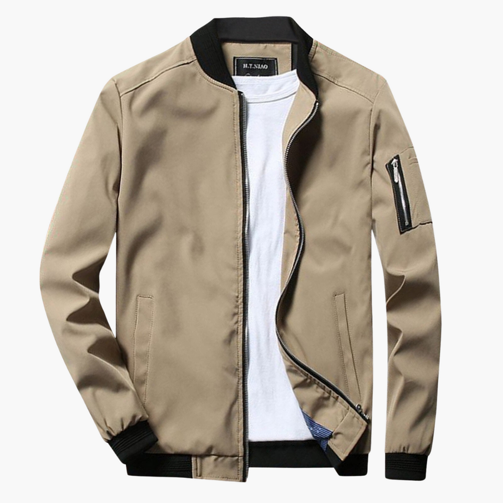 Beige bomber jacket with black trim on a white background