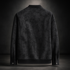 Black leather jacket shown from the back on a dark background