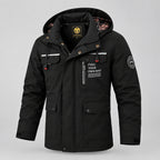 Black jacket with visible branding against a snowy background