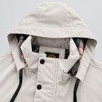 Close-up of a beige hooded jacket with plaid lining on a white background
