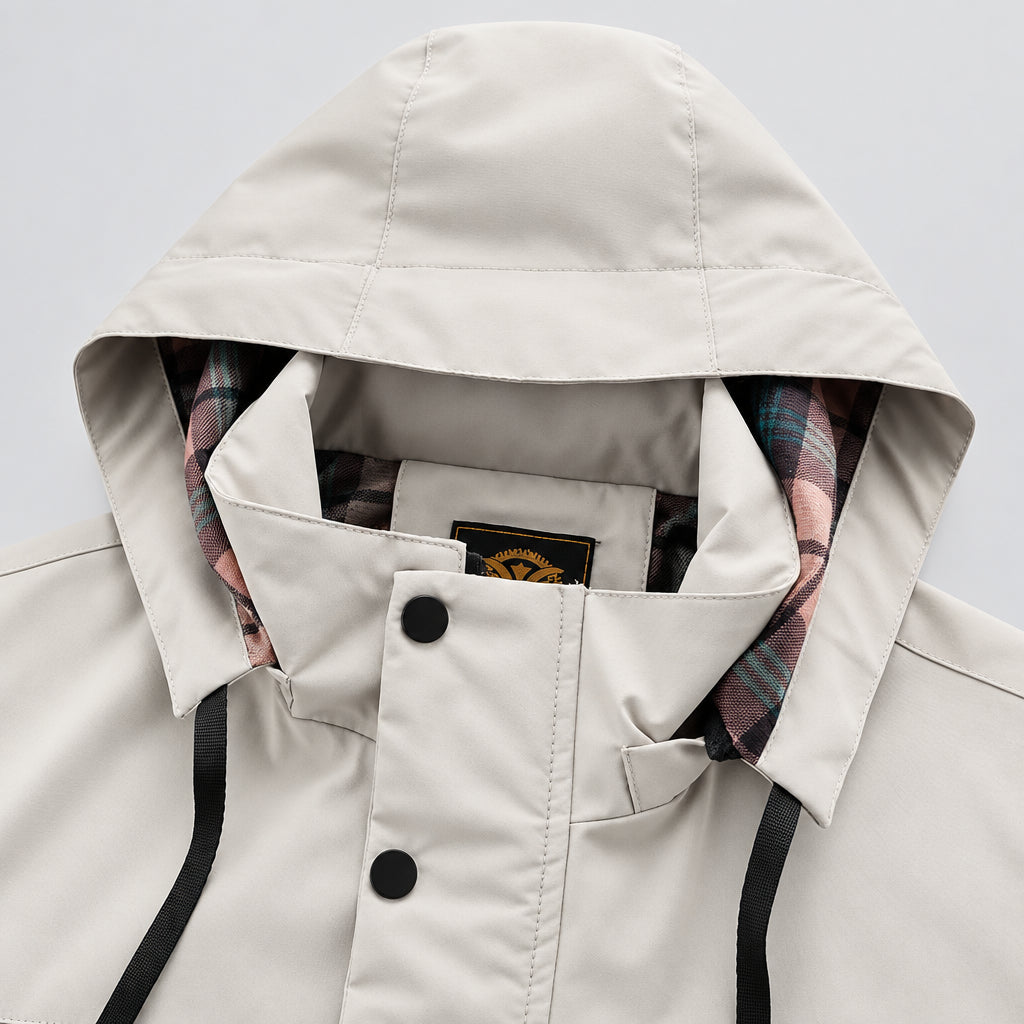Close-up of a beige hooded jacket with plaid lining on a white background