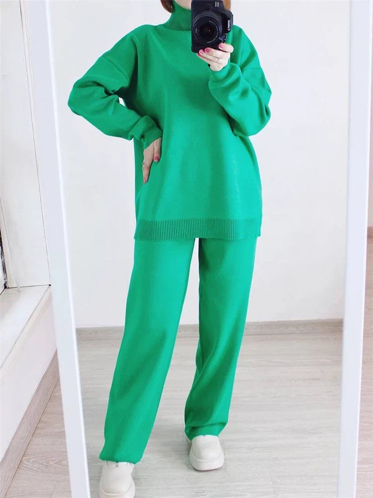 Person wearing a green outfit taking a mirror selfie.