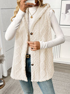 Woman wearing a cream-colored fleece vest over a white long-sleeve shirt on a white background