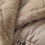 Close-up of a beige puffer jacket with fur lining