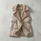 Beige puffer vest with fur trim on a light gray background